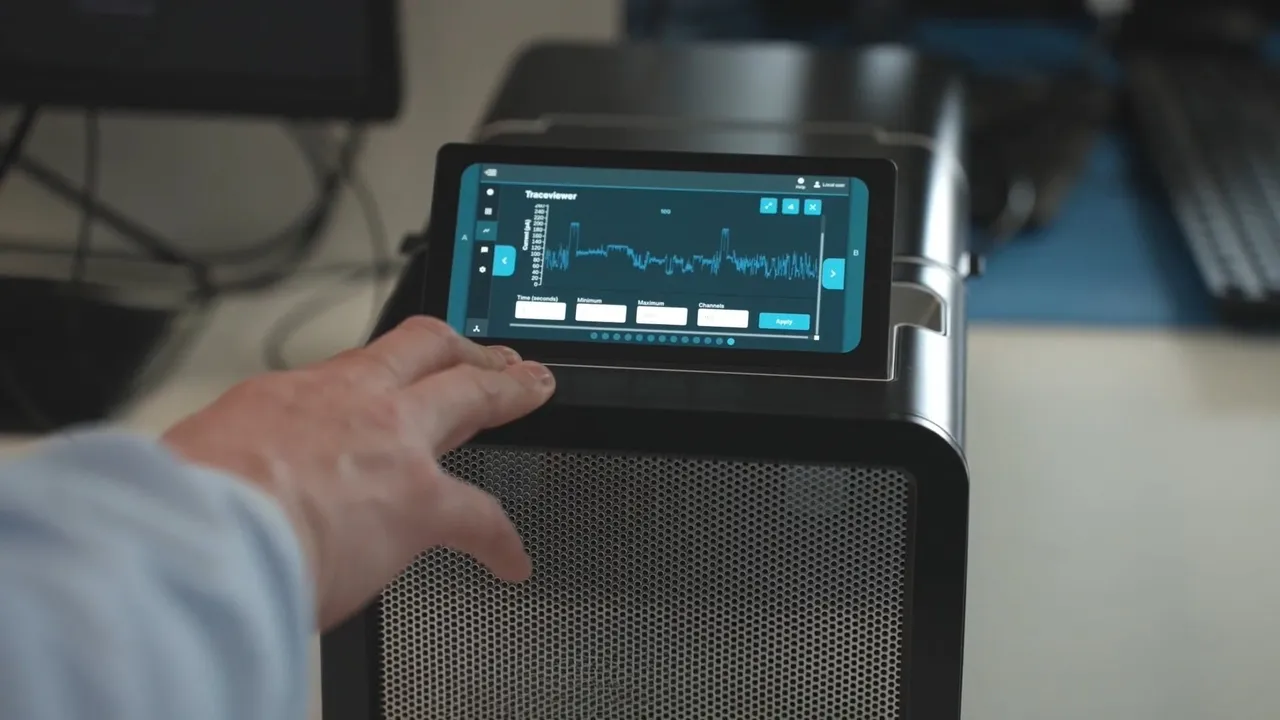 Close up of a P2 Integrated sequencing device with a person's hand interacting with the screen that shows a graph