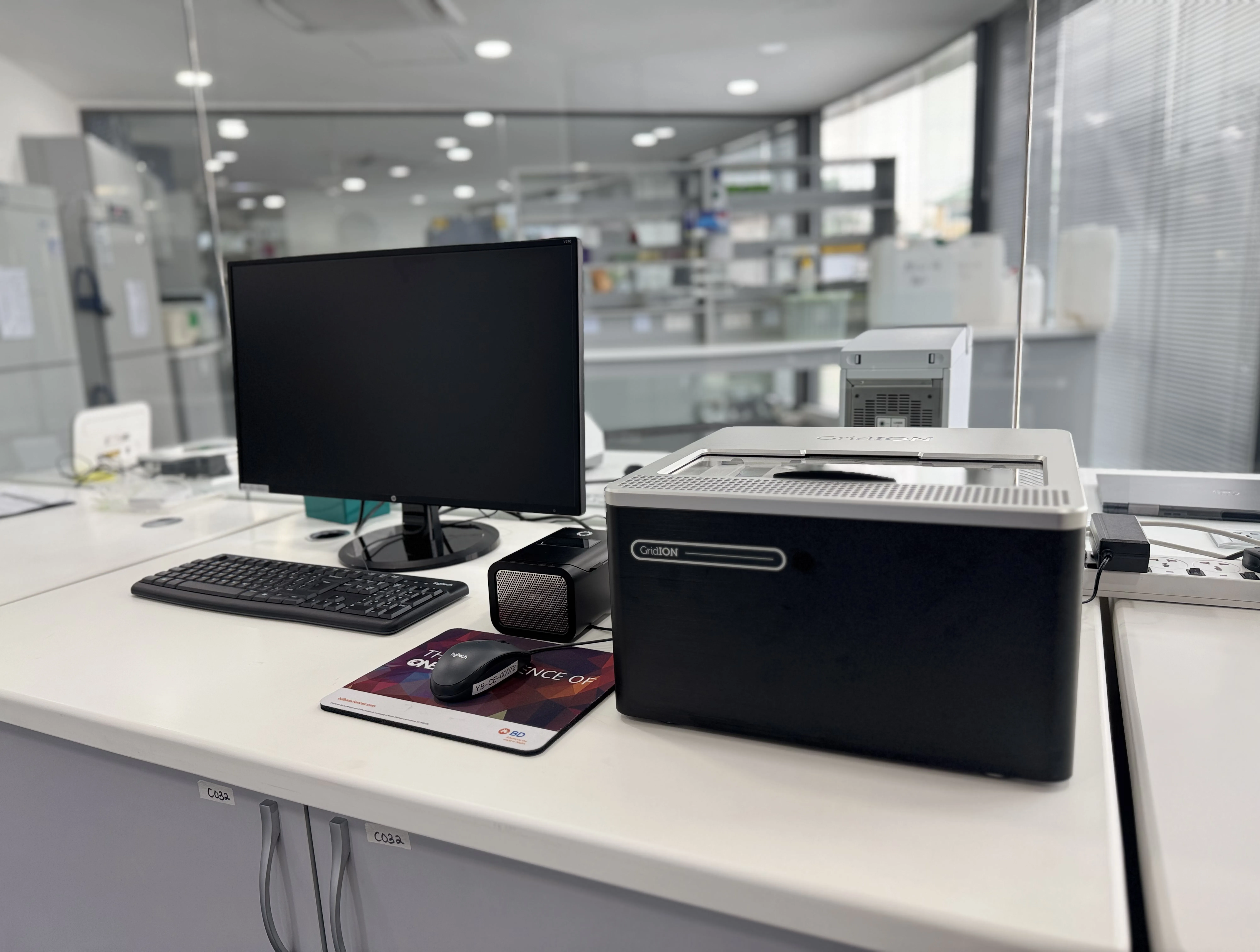 Image of a gridION, a P2, and computer screen in a white lab