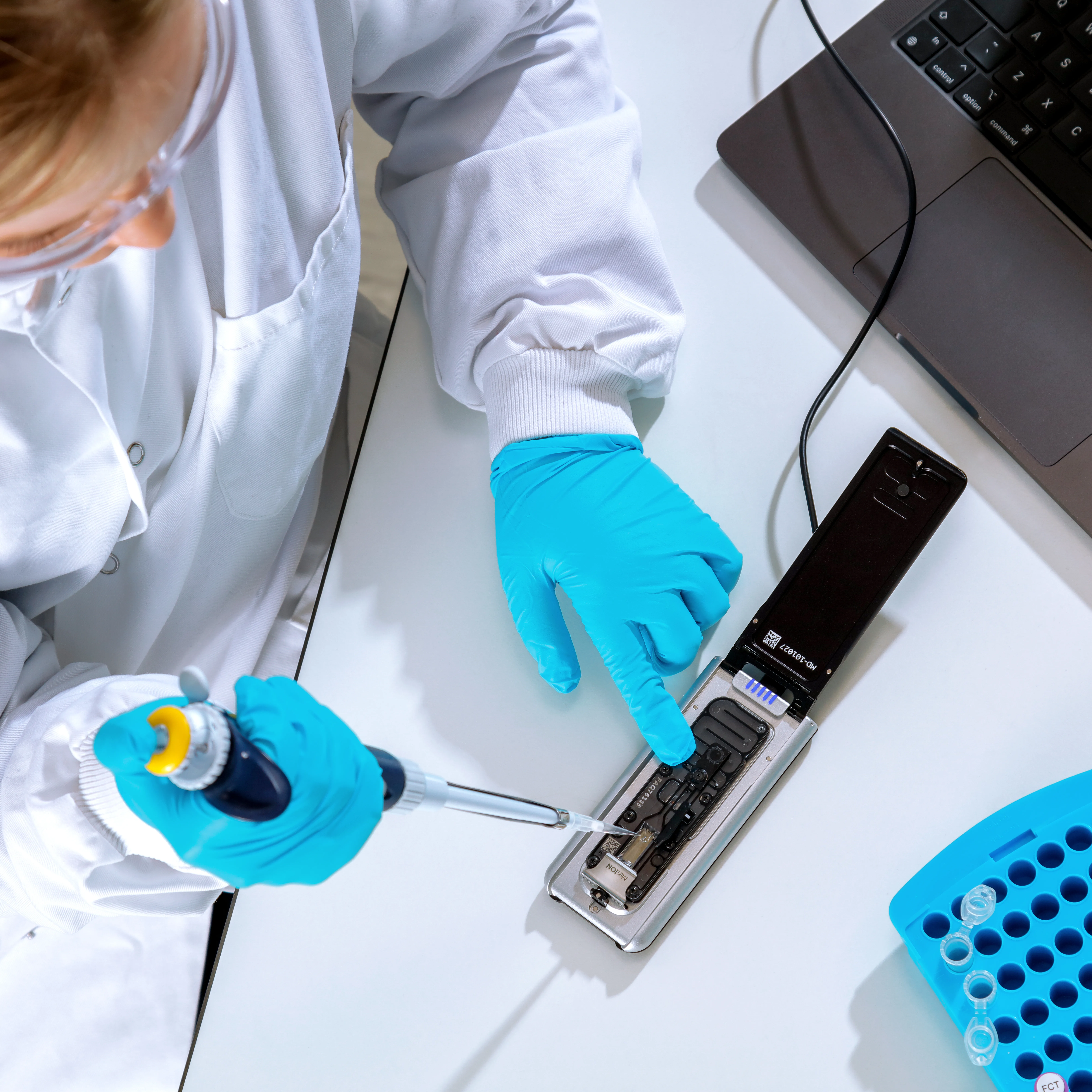 ML002f Mk1D attached to a laptop on a lab workbench - open, pipetting above - Option 3