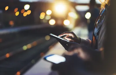 woman holding smartphone in hand